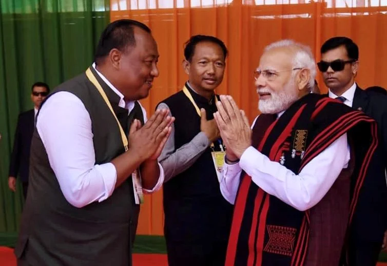 Benjamin Yepthomi greeting Prime Minister Narendra Modi with folded hands at a public event.